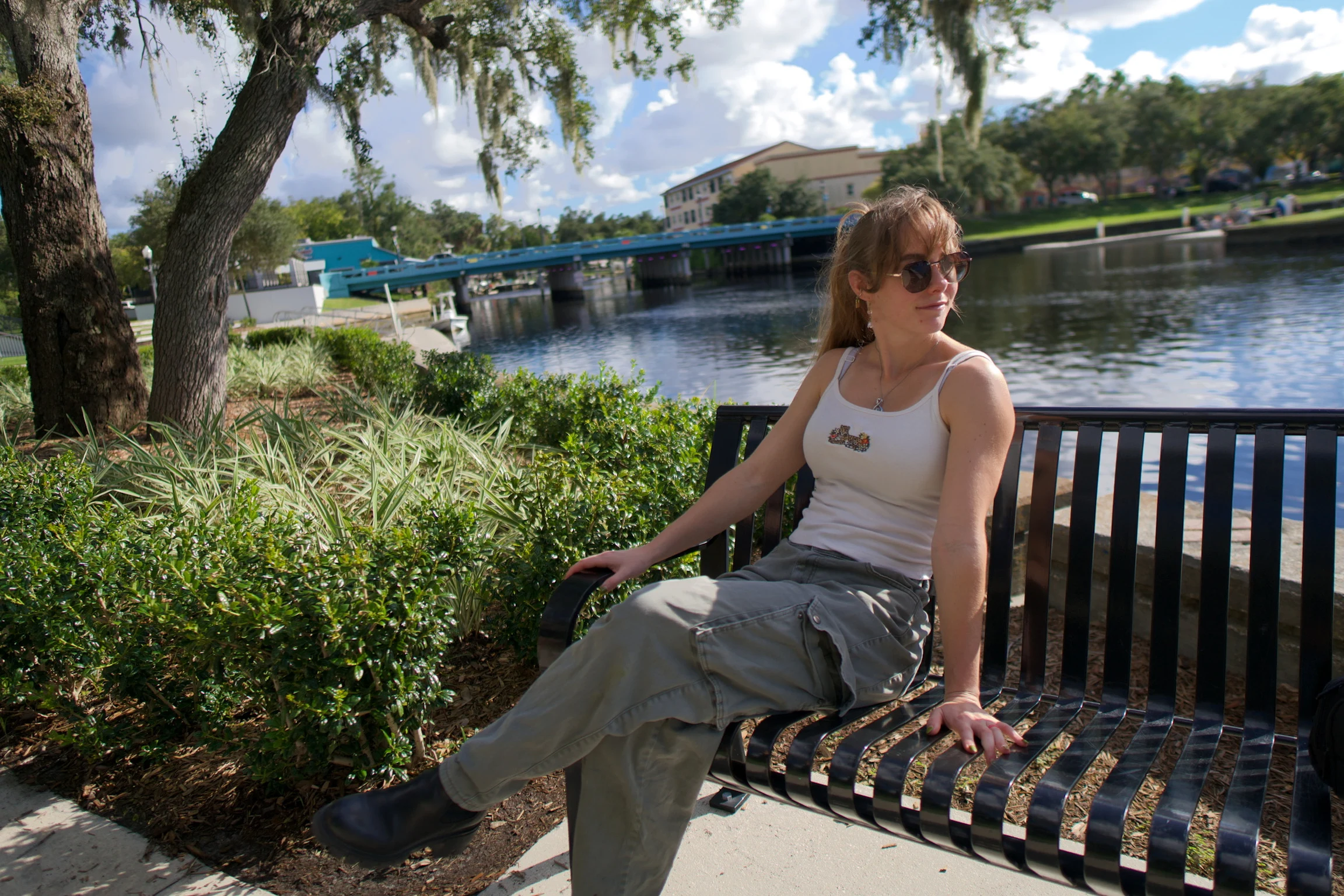 A woman on a bench looking over her shoulder at the water